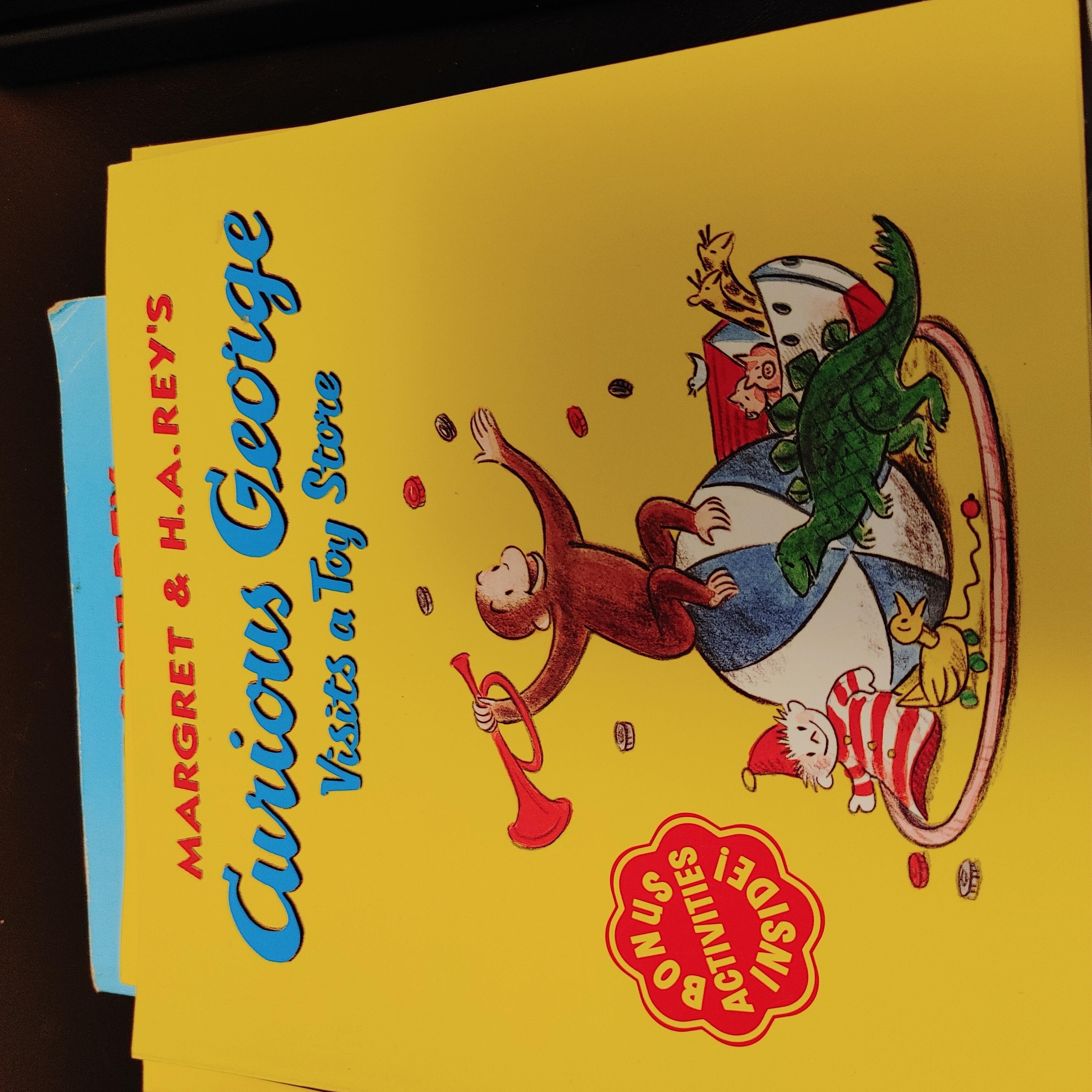 Curious George books- First Day of School and Visits a Toy Store